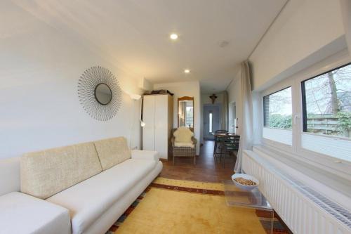 a living room with a white couch and a window at NS 6a Seestern Wremen in Wremen