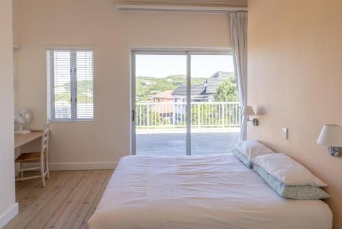a bedroom with a bed and a large window at 53 Island Road in Seafield