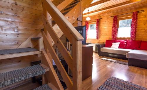 a room with a staircase in a log cabin at Apartments Brunarica in Moravske Toplice