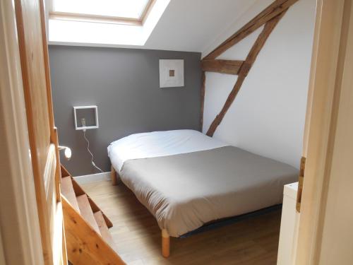 a bedroom with a bed in a room with a window at Gîte du Clos de Gamel in Lascabanes