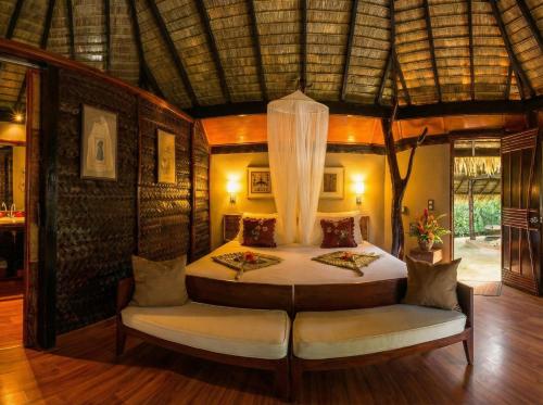 a bedroom with a bed in a room at Fare PEA ITI Romantic Lodge in Patio