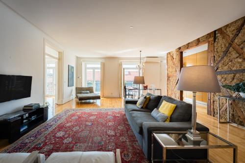 a living room with a couch and a table at Eighteen21 Houses - Casa de São Paulo in Lisbon