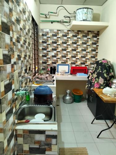 a kitchen with a sink and a counter top at Mini Banglo in Sylhet