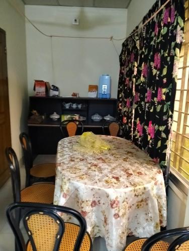 a table in a room with a table and chairs at Mini Banglo in Sylhet