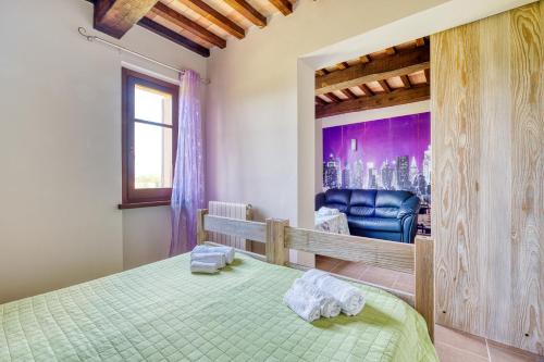 a bedroom with a bed with towels on it at Casale Rialto in Montefalco