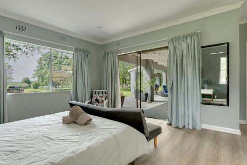 a bedroom with a bed and a large window at Vaal River House @ Lochvaal in Vanderbijlpark