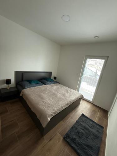 a bedroom with a bed and a large window at Apartmán ALEX Choceň in Choceň