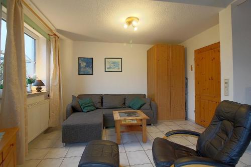 a living room with a couch and a table at STW28a Delphin in Dorum-Neufeld