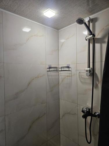 a bathroom with a shower with a glass door at For Family in Aparan