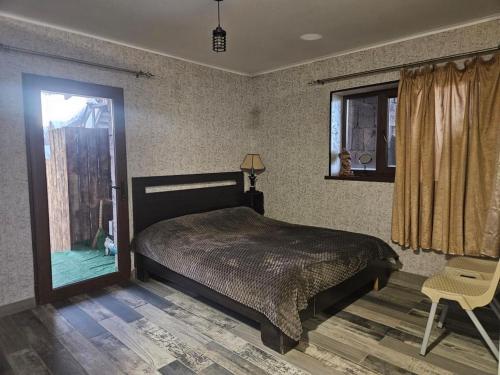 a bedroom with a bed and a window and a chair at For Family in Aparan