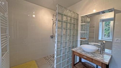 a bathroom with a sink and a shower at Les tâches in Pensol