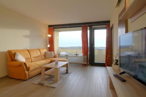 a living room with a couch and a flat screen tv at Apartment 545 in Hohegeiß