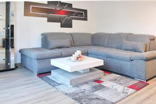 a living room with a blue couch and a white coffee table at Spreemitte in Lübbenau