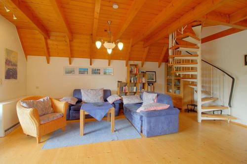 a living room with a blue couch and chairs at SV2 Opi-Huck-Stroot 37 in Dorum-Neufeld