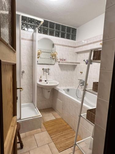 a bathroom with a sink and a tub and a toilet at Chata Rychnovanka in Zdobnice