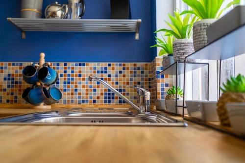 a kitchen counter with a sink in a kitchen at Thyme Cottage in Beccles