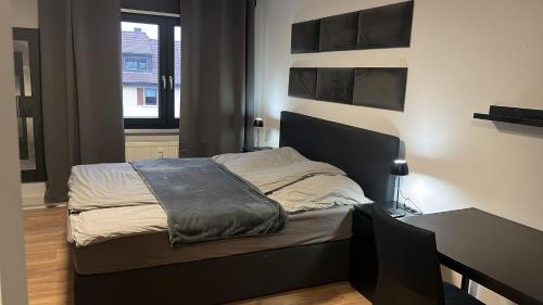 a bedroom with a bed and a table in it at Wohnung im Zentrum von Gaggenau! in Gaggenau