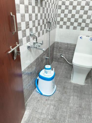a bathroom with a toilet and a water fountain at Hotel Mount Royale in Hyderabad
