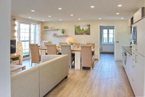 a kitchen and dining room with a table and chairs at Quartier Spreestraße - App 5 in Burg