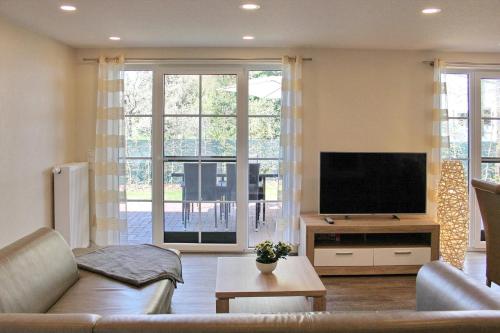 a living room with a couch and a flat screen tv at Quartier Spreestraße - App 5 in Burg