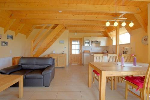 a living room with a couch and a table at SV3 Mellumplate 56 in Dorum-Neufeld