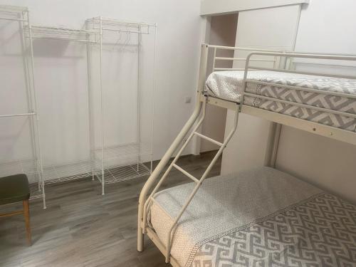 a bunk bed room with two bunk beds and a chair at Casita Mona Marcoin in Toledo