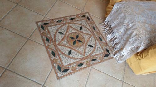 a rug on the floor with a design on it at Casa Allende in Bosa