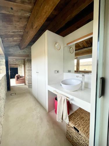 a bathroom with a sink and a mirror at Equisoain Ala Sur in Monreal