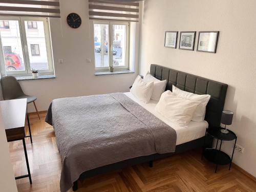 a bedroom with a large bed with white pillows at ✪ FirstClass-Apartment in Leipzig-Gohlis ✪ in Leipzig