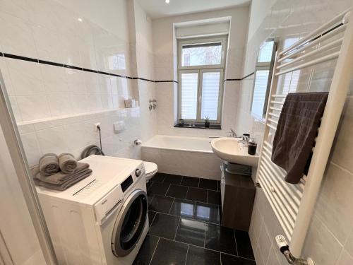 a bathroom with a washing machine and a sink at ✪ FirstClass-Apartment in Leipzig-Gohlis ✪ in Leipzig
