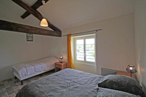 a bedroom with two beds and a window at Gîte 87G7461 in Saint-Mathieu