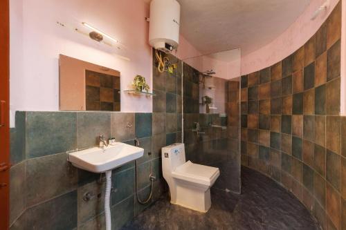 a bathroom with a sink and a toilet at The Rustic Ridge Villa by StayJadePool1hr E-city in Denkanikottai
