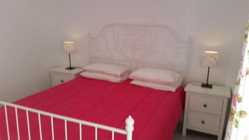 a bedroom with a white bed with two pillows at Anixi - Primavera Mykonos in Ornos