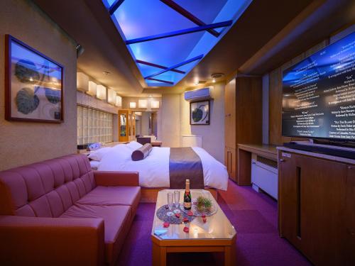 a hotel room with a bed and a tv at Water Hotel Mw (Love Hotel) in Saitama