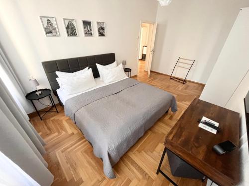 a bedroom with a large bed and a wooden floor at FirstClass 2R_Apartment in Leipzig in Leipzig