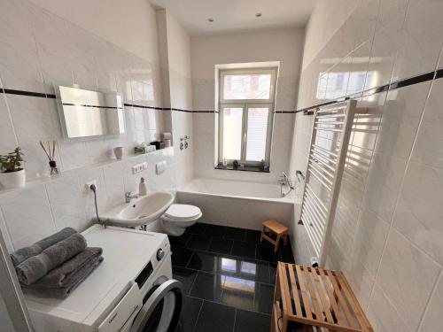 a white bathroom with a sink and a toilet at FirstClass 2R_Apartment in Leipzig in Leipzig