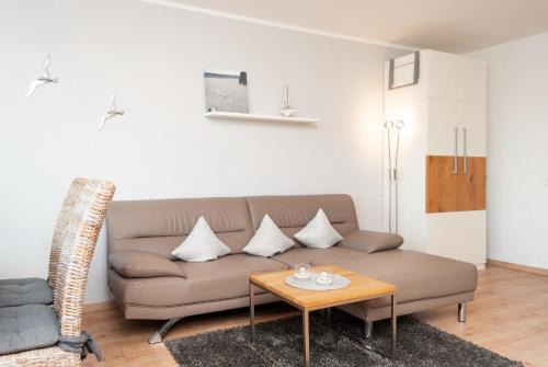 a living room with a couch and a table at Hanseatic 111 in Duhnen
