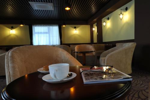 a coffee cup sitting on a table in a room at Alpha Hotel Ulaanbaatar in Ulaanbaatar