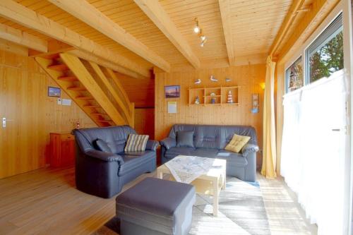 a living room with two couches and a table at SR Eversand 11 in Dorum-Neufeld