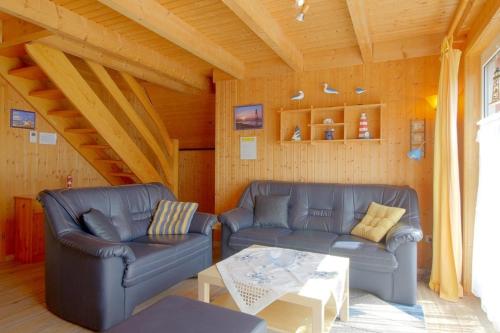 a living room with two couches and a coffee table at SR Eversand 11 in Dorum-Neufeld