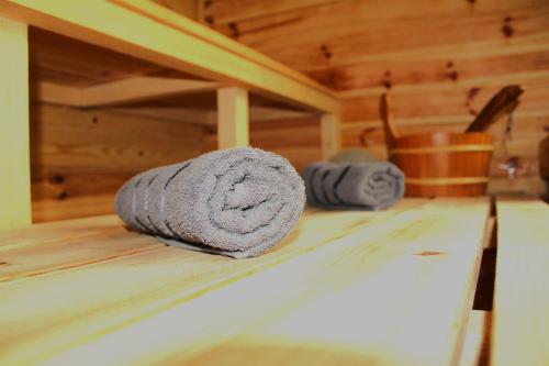 a rolled up towel sitting on top of a wooden table at Hámori Álom in Miskolc
