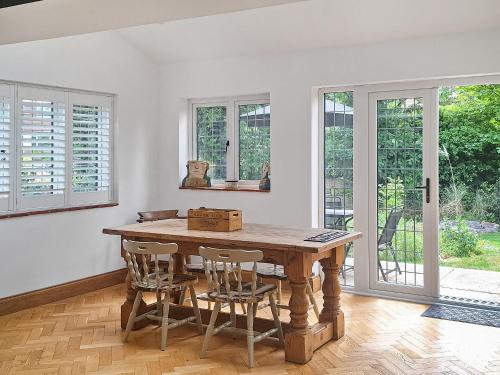 a dining room with a wooden table and chairs at Mill House in Lowestoft