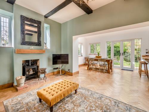 a living room with a fireplace and a tv at Mill House in Lowestoft