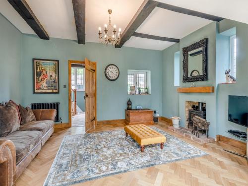 a living room with a couch and a fireplace at Mill House in Lowestoft