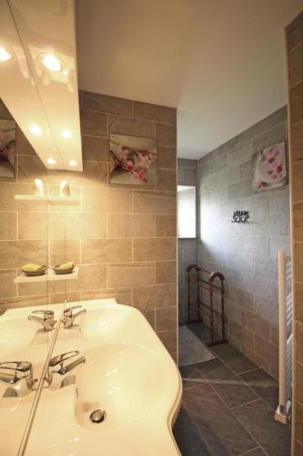 a bathroom with a white sink and a mirror at La chaudière in Saint-Auvent