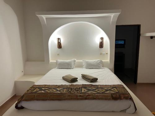 a bedroom with a bed with two pillows on it at Kalao beach in Cap Skirring