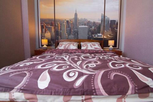 a bedroom with a bed with a large window at Apartment-Lawina in Sumy