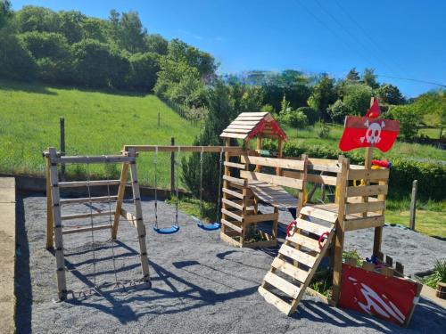 a playground with a slide and a swing at Gasthaus Paula in Üdersdorf