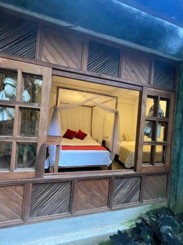 a bedroom with a bed inside of a building at Casa Kwalama in Santa Marta