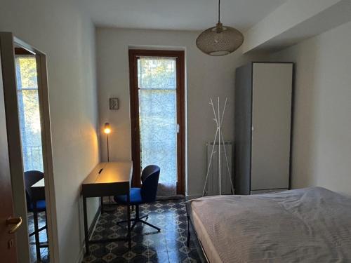 a bedroom with a desk and a bed in a room at Lavinia in Oggebio